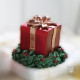Candela natalizia a forma di pacchettino regalo